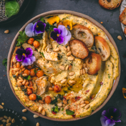 a bowl of spinach artichoke hummus